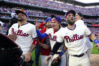 Philadelphia Phillies' Bryce Harper and his teammmates celebrate a win over the Atlanta Braves after Game 4 of baseball's National League Division Series, Saturday, Oct. 15, 2022, in Philadelphia. The Philadelphia Phillies won, 8-3. (AP Photo/Matt Rourke)