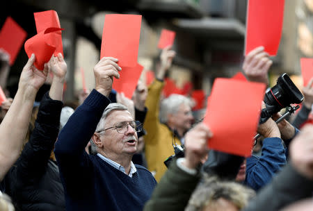 FILE PHOTO: People raise red cards to protest against government's plans to overhaul the Hungarian Academy of Sciences outside the Ministry for Innovation and Technology in Budapest, Hungary, March 21, 2019. REUTERS/Tamas Kaszas/File Photo