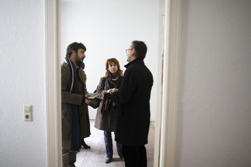 Estate agent Tomas Nyisztor, right, talks to Italian couple Andrea Bricconi, left, Claudia Mosca, center, during an inspection in an empty apartment at the district Prenzlauer Berg in Berlin, Thursday, Nov. 1, 2012. Buying a home in Berlin is widely viewed as one of the safest investments a German, or any European, can make. That is why some real-estate experts are worried the market could get overheated.(AP Photo/Markus Schreiber)