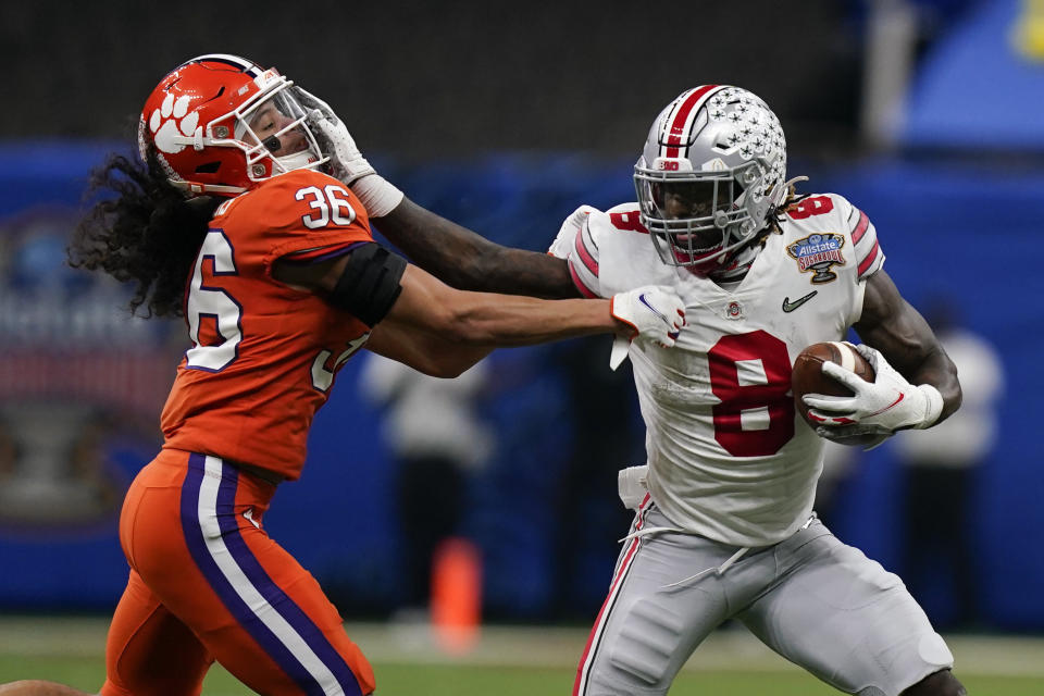 Ohio State running back Trey Sermon runs past Clemson safety Lannden Zanders during the first half of the Sugar Bowl NCAA college football game Friday, Jan. 1, 2021, in New Orleans. (AP Photo/Gerald Herbert)