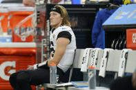 Jacksonville Jaguars quarterback Trevor Lawrence sits on the bench in the closing minutes of a loss to the Los Angeles Rams during the second half of an NFL football game Sunday, Dec. 5, 2021, in Inglewood, Calif. (AP Photo/Jae C. Hong)