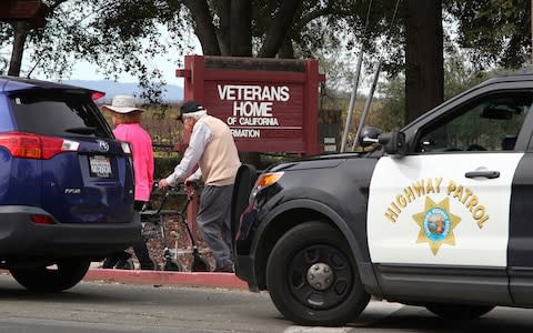 People walk to the information center at the Veterans Home of California in Yountville - Credit: AP