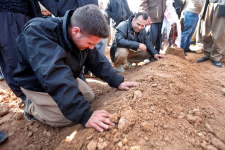 Mourners react during a funeral of victims who were killed in a bomb attack at the offices of the Democratic Party of Iranian Kurdistan (PDKI) in Koy Sanjak, east of Erbil, Iraq, December 21, 2016. REUTERS/Azad Lashkari