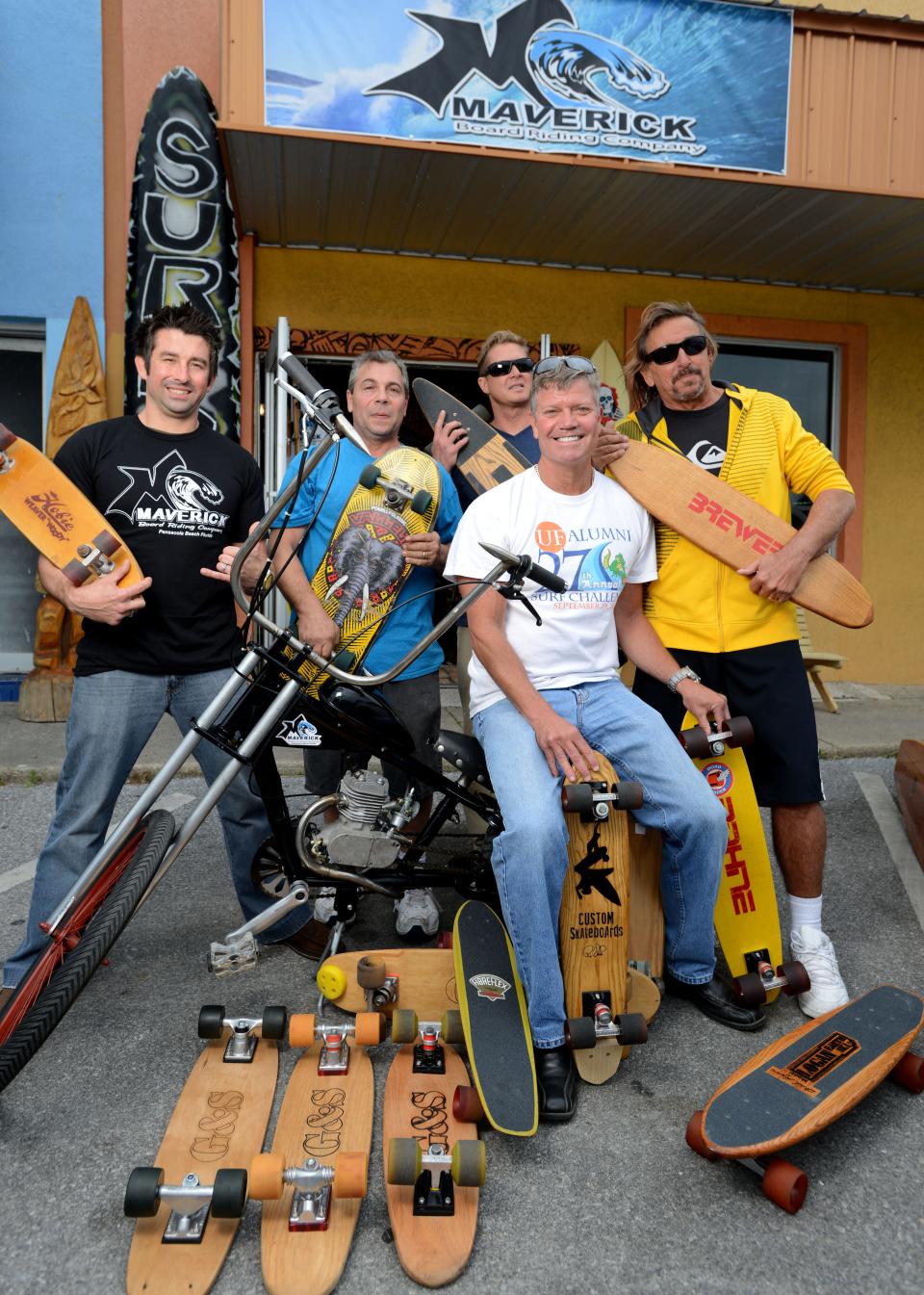 From left, legendary Pensacola skateboarders Brian McKinney, Freddy Coury, Yancy Spencer IV, Rip Hanks and Freddy Esposito are photographed outside Maverick Boarding Co. in 2014 before they hosted a reunion of 1970s era skateboarders in the area.