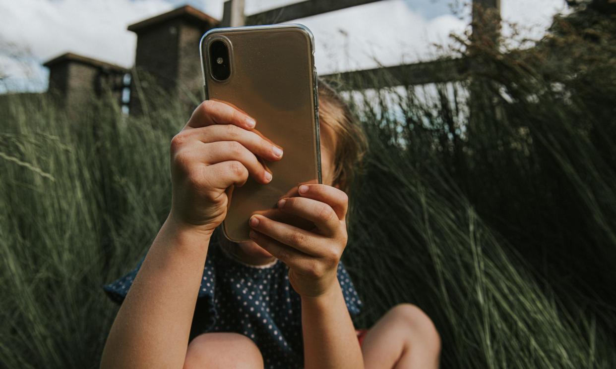 <span>Children are spending more time on phones, with girls more likely to use social media.</span><span>Photograph: Catherine Falls Commercial/Getty Images</span>