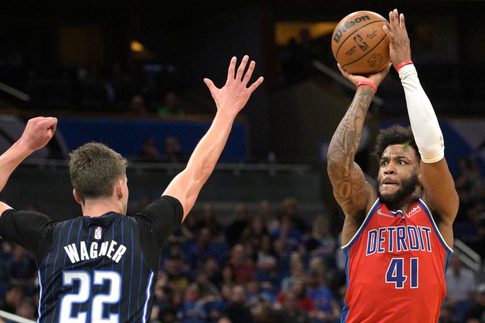 Detroit Pistons forward Saddiq Bey (41) shoots in front of Orlando Magic forward Franz Wagner (22) during the first half of an NBA basketball game Thursday, March 17, 2022, in Orlando, Fla. (AP Photo/Phelan M. Ebenhack)