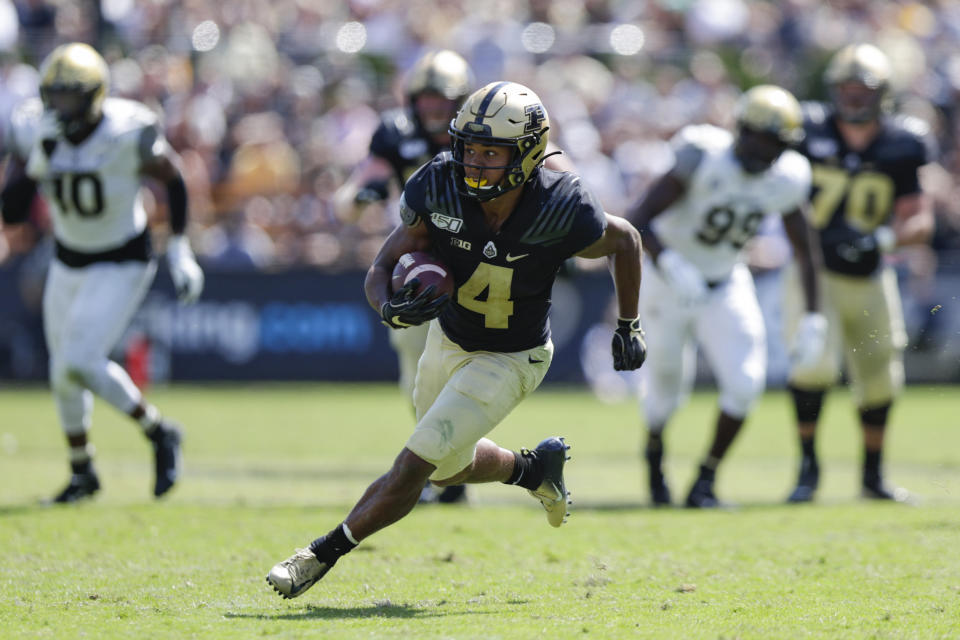 In this photo taken on Saturday, Sept. 7, 2019, Purdue wide receiver Rondale Moore (4) runs after a catch against Vanderbilt during the second half of an NCAA college football game in West Lafayette, Ind. First, Rondale Moore couldn't wait to get back on the field with Purdue. Then, after the COVID-19 pandemic hit and Big Ten leaders postponed the season, Purdue's speedy receiver couldn't wait to get to the NFL. Now, after announcing he would would skip this season to prepare for the draft, Moore is back on the practice field and the Boilermakers couldn't be happier.(AP Photo/Michael Conroy)