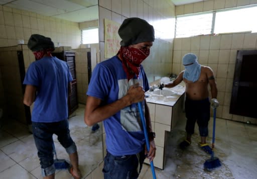 Students clean a bathroom at the National University (UNAN), occupied by protesters for over a month