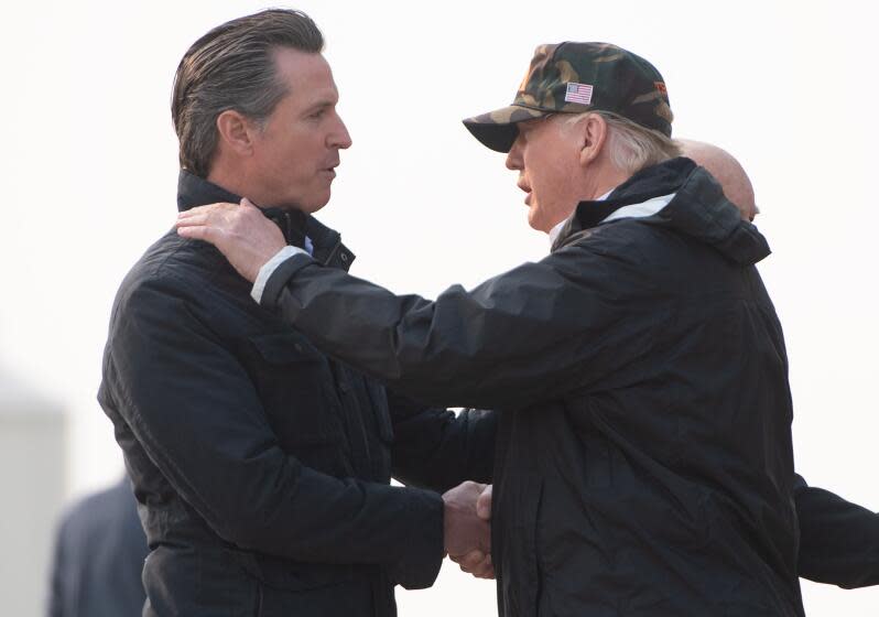 US President Donald Trump greets California Governor-elect Gavin Newsom (L) as he disembarks from Air Force One upon arrival at Beale Air Force Base in California, November 17, 2018, as he travels to view wildfire damage. - President Donald Trump arrived in California to meet with officials, victims and the "unbelievably brave" firefighters there, as more than 1,000 people remain listed as missing in the worst-ever wildfire to hit the US state. (Photo by SAUL LOEB / AFP) (Photo credit should read SAUL LOEB/AFP/Getty Images)