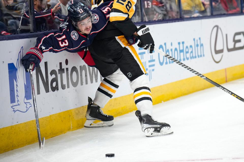 Oct 22, 2022; Columbus, Ohio, USA;  Columbus Blue Jackets forward Johnny Gaudreau (13) is pinned against the wall by Pittsburgh Penguins defenseman Marcus Pettersson (28) during the third period of the hockey game between the Columbus Blue Jackets and the Pittsburgh Penguins at Nationwide Arena. Mandatory Credit: Joseph Scheller-The Columbus Dispatch