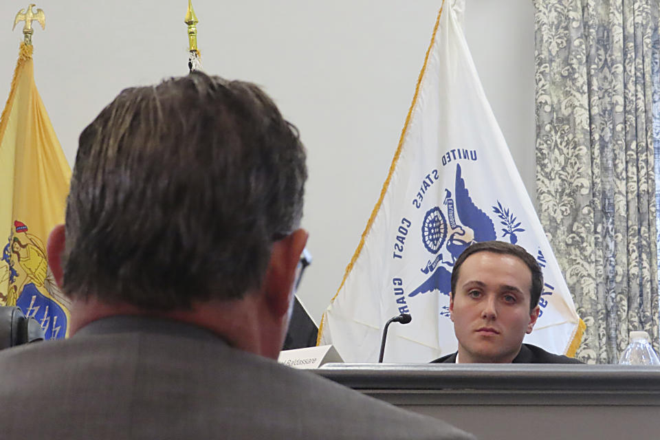 Gaven Puchinsky is questioned at a hearing Wednesday, Jan. 10, 2024, in Union, N.J. into a fatal cargo ship fire in Newark N.J. last July that killed two firefighters. Puchinsky testified a Jeep he was using to push vehicles onto the ship burst into flames aboard the vessel. (AP Photo/Wayne Parry)
