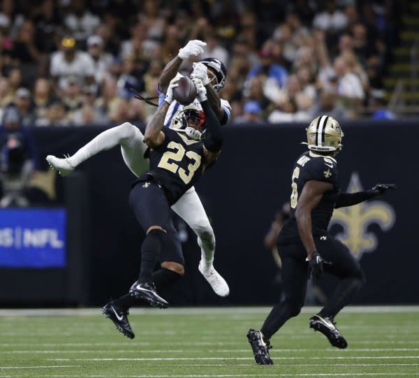 New Orleans Saints cornerback Marshon Lattimore (23) snags an interception in front of Tennessee Titans wide receiver DeAndre Hopkins on Sunday at the Caesars Superdome in New Orleans. Photo by AJ Sisco/UPI