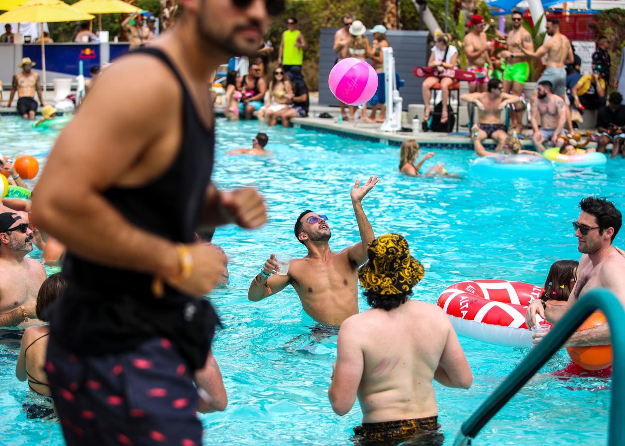 Festivalgoers play with beach balls in the pool during Splash House at the Saguaro in Palm Springs, Calif., Saturday, June 10, 2023. 