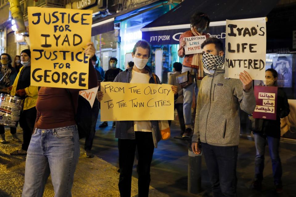 Israeli demonstrators carry placards during a demonstration condemning the shooting of Iyad Hallak, a disabled Palestinian man who was shot dead by Israeli police: Photo by AHMAD GHARABLI/AFP via Getty Images