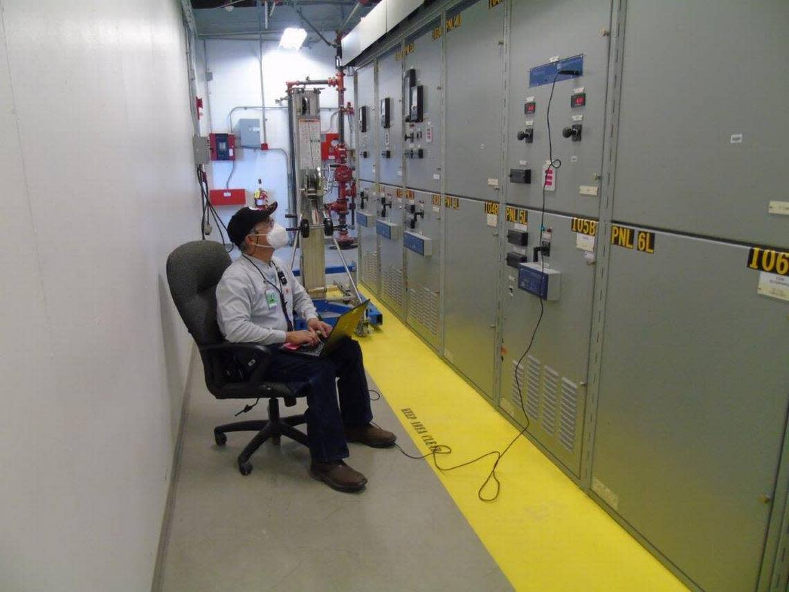 A Hanford worker wears a mask as he tests electrical breakers. Workers are now ordered to wear masks indoors, even if they are vaccinated against COVID-19.