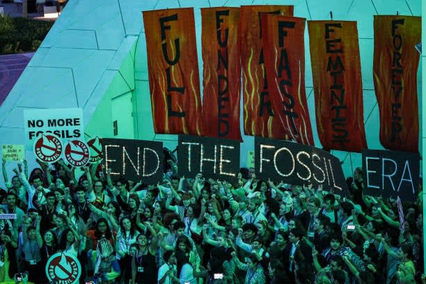 Climate activists attend a protest against fossil fuels during the United Nations Climate Change Conference Cop28 in Dubai on 12 December 2023 (AFP via Getty Images)