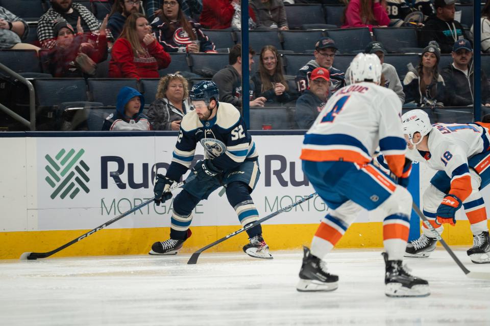 Oct 28, 2023; Columbus, Ohio, United States;
Columbus Blue Jackets right wing Emil Bemstrom (52) skates down the rink with the puck against New York Islanders defenders during the third period of their game on Saturday, Oct. 28, 2023 at Nationwide Arena.