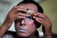 Teeraphong Meesat, 29, known as teacher Bally applies make up before his english class at the Prasartratprachakit School in Ratchaburi province