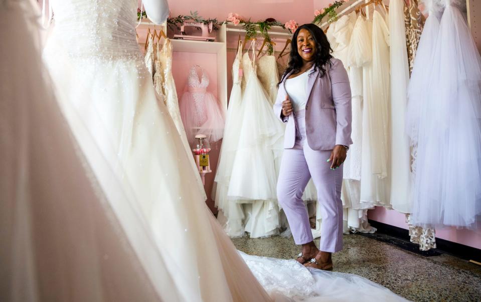 Raeshawn Bumphers, owner of Pink Poodle Dress Lounge, stands inside her store in Detroit on Thursday, June 1, 2023. According to Bumphers, she removed blight from three locations since opening her store in 2018.