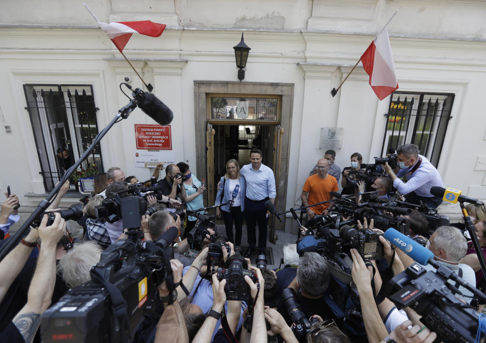 FILE - In this June 28, 2020, file photo, Presidential candidate Rafal Trzaskowski with his wife Malgorzata addresses the media after casting his vote during presidential election in Warsaw, Poland. Trzaskowski and President Andrzej Duda are heading into a tight presidential runoff that is seen as an important test for populism in Europe. The Sunday, July 12 election comes after a bitter campaign that has exacerbated a conservative-liberal divide in the country. (AP Photo/Petr David Josek, File)