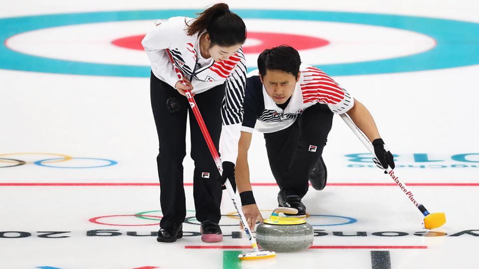 <p>Jang Hye-ji and Lee Ki-jeong of South Korea compete during the Curling Mixed Doubles.</p>