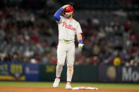 Philadelphia Phillies' Bryce Harper adjusts his helmet while on second base during the seventh inning of a baseball game against the Los Angeles Angels, Monday, April 29, 2024, in Anaheim, Calif. (AP Photo/Ryan Sun)