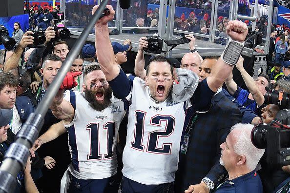 2019:  Julian Edelman #11 of the New England Patriots and teammate Tom Brady #12 celebrate at the end of the Super Bowl LIII at Mercedes-Benz Stadium on February 3, 2019 in Atlanta, Georgia. The New England Patriots defeat the Los Angeles Rams 13-3.  (Photo by Harry How/Getty Images)