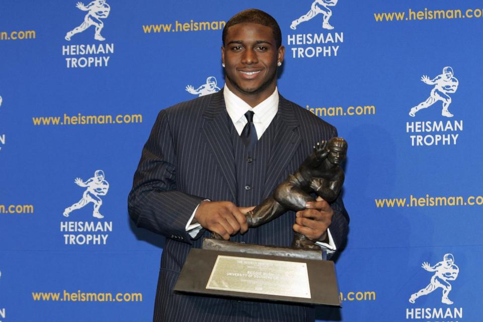 PHOTO: Reggie Bush, University of Southern California tailback holds the Heisman Trophy during the 2005 Heisman Trophy presentation, in New York City, Dec. 10, 2005. (Michael Cohen/WireImage via Getty Image)