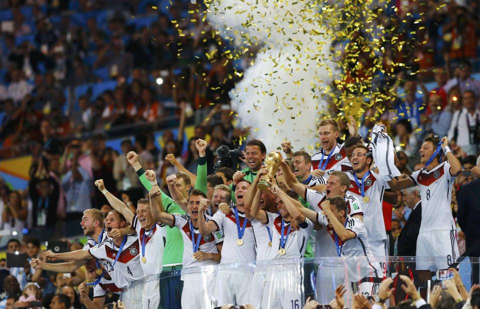 Germany's players lift the World Cup trophy as they celebrate their 2014 World Cup final win against Argentina at the Maracana stadium in Rio de Janeiro in this July 13, 2014 file photo. REUTERS/Darren Staples/Files (BRAZIL - Tags: SOCCER SPORT WORLD CUP TPX IMAGES OF THE DAY)