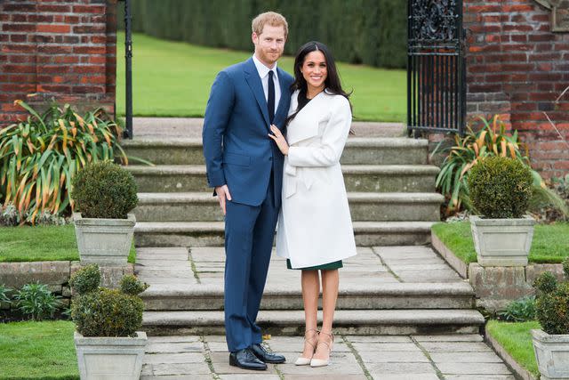 <p>Samir Hussein/Samir Hussein/WireImage</p> Prince Harry and Meghan Markle in the Sunken Garden at Kensington Palace after announcing their engagement on Nov. 27, 2017.