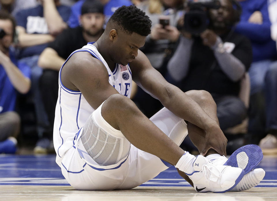 Duke’s Zion Williamson sits on the floor following a injury during the first half of an NCAA college basketball game against North Carolina in Durham, N.C., Wednesday, Feb. 20, 2019. (AP Photo/Gerry Broome)