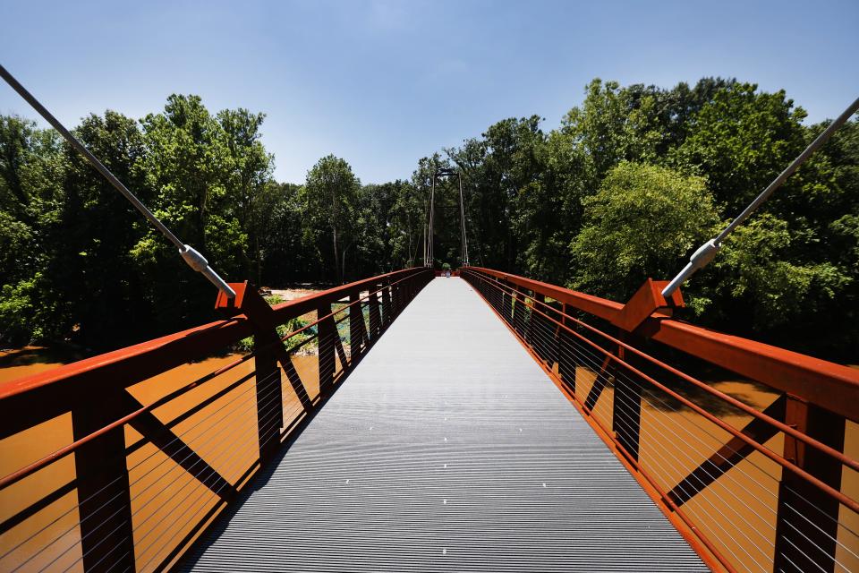 A 270 foot long steel suspension bridge over the Wolf River is one of the largest undertakings in the Greenway expansion project, seen here nearly completed on Thursday, June 17, 2021. 