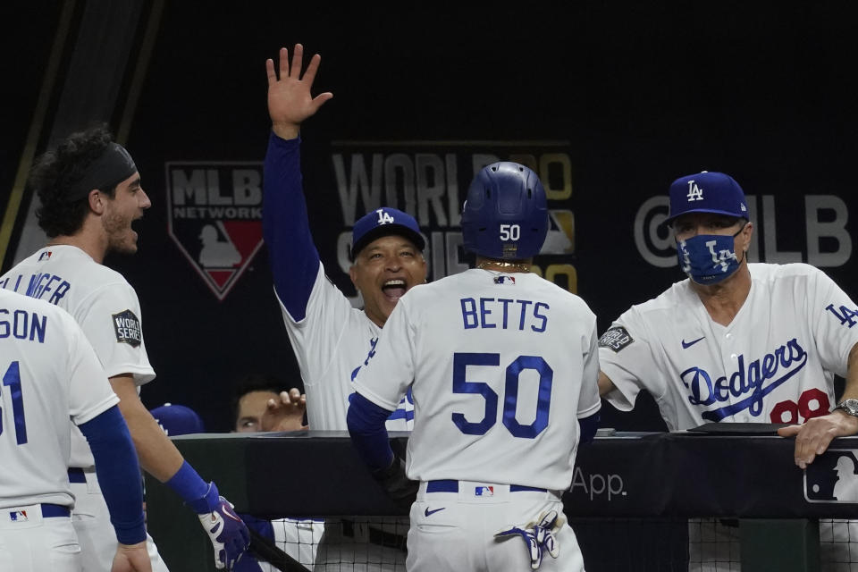 Los Angeles Dodgers' Mookie Betts celebrates after scoring against the Tampa Bay during the sixth inning in Game 6 of the baseball World Series Tuesday, Oct. 27, 2020, in Arlington, Texas. (AP Photo/Tony Gutierrez)