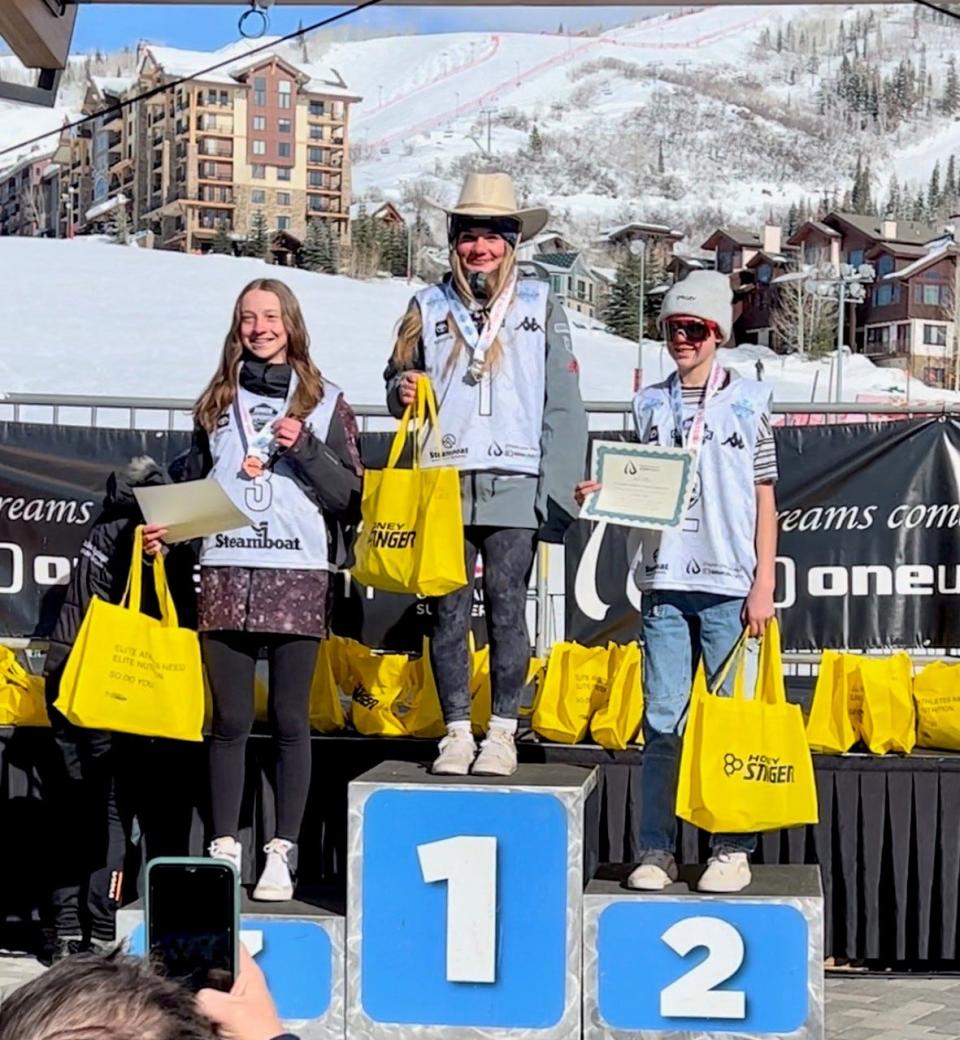 Hopewell Junction's Eden Kruger, center, stands on the medal podium after taking first in the Under-15 mogul skiing competition at the U.S. Freestyle Junior Nationals in Colorado.
