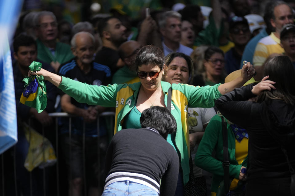 A supporter of Brazilian President Jair Bolsonaro is searched before entering a rally in Juiz de Fora, Minas Gerais state, Brazil, Tuesday, Aug. 16, 2022. Bolsonaro formally began his campaign for re-election in this town where he was stabbed during his 2018 campaign. General elections are set for Oct. 2. (AP Photo/Silvia Izquierdo)