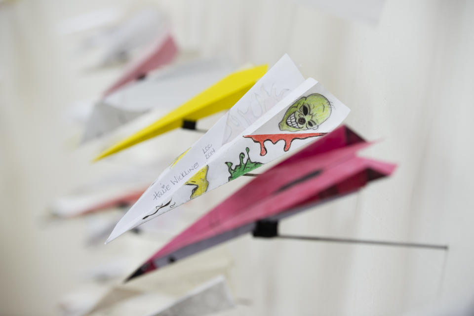 Benjamin Wills' installation titled Airplanes is displayed, Thursday, May 2, 2019 at the Eastern State Penitentiary, which is now a museum in Philadelphia. The paper airplanes were sent to Wills from his correspondence with incarcerated people. (AP Photo/Matt Rourke)