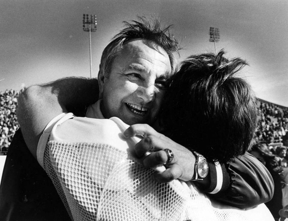 Eastern Kentucky coach Roy Kidd hugged senior quarterback Tuck Woolum after the Colonels won the Division I-AA national title on Dec. 18, 1982, in Wichita Falls, Texas. Eastern defeated Delaware 17-14 for their second national title in four years.