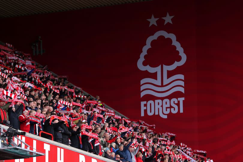 Nottingham Forest fans show their support with scarves during the Premier League match between Nottingham Forest and Manchester City at City Ground on April 28, 2024
