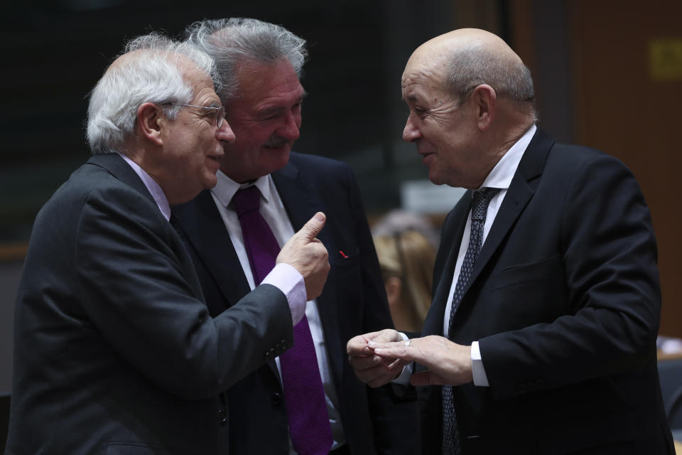 French Foreign Minister Jean-Yves Le Drian, right, speaks with Spanish Foreign Minister Josep Borrell, left, and Luxembourg's Foreign Minister Jean Asselborn during an EU Foreign Ministers meeting at the European Council headquarters in Brussels, Monday, Feb. 18, 2019. US President Donald Trump's demand that European countries take back their nationals fighting in Syria is receiving mixed reactions, as nations pondered how to bring home-grown Islamic State extremists to trial. (AP Photo/Francisco Seco)