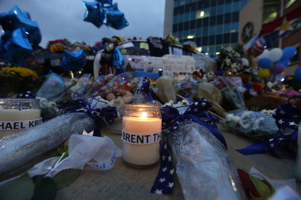 Candles placed in honor of slain Dallas police officers sit in front of a makeshift memorial in honor of the slain Dallas police officers