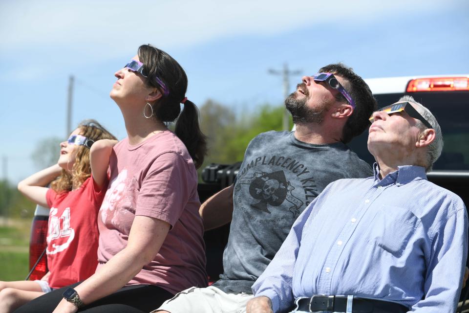 From left to right; Addie Clay 7, Allsion Clay 46, Mike Clay 51, and Jimmy Clay 84, stare up into the sun as the eclipse starts during the 2024 Solar Eclipse in Bessie, Tenn., on Monday, April 8, 2024.