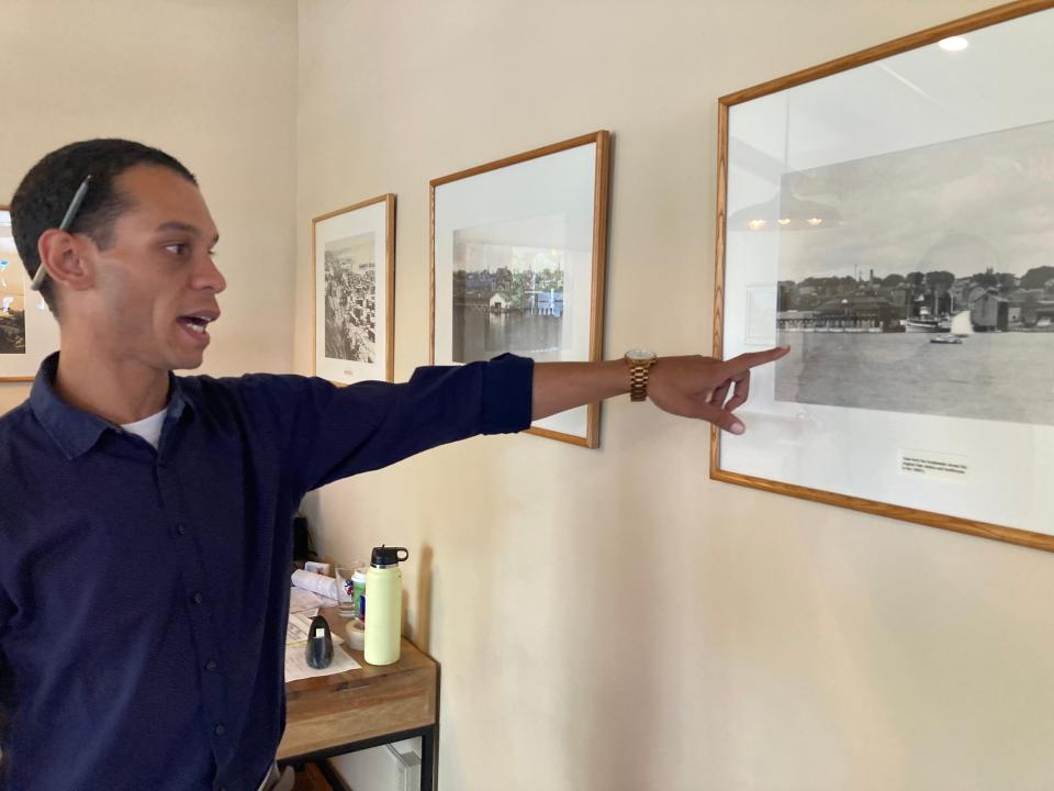 Tony Elmore, supervisor of Gobeille Hospitality, talks about photos on the wall of one of the restaurants he manages, Shanty on the Shore in Burlington, on July 26, 2023.