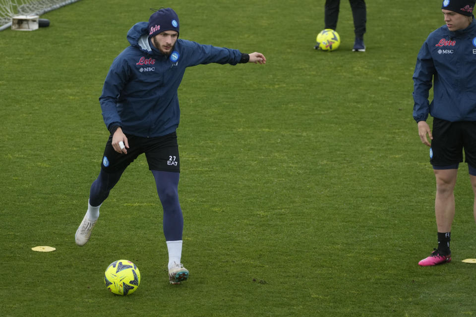 Napoli's Khvicha Kvaratskhelia warms up during a training session at the Club headquarters in Castel Volturno, Wednesday, April 5, 2023. Unlike other major cities in Italy, Naples has only one major soccer team and the fan support for Napoli is felt on every street and alleyway. Lobotka, who developed with Ajax’s junior squad and then played for Danish club Nordsjaelland and Spanish side Celta Vigo before transferring to Italy, had never experienced anything like Napoli. (AP Photo/Gregorio Borgia)