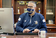 In this November 2020 photo, provided by Eugene "Geno" Thomas, Thomas, superintendent of the Lowellville, Ohio, School District, works in his office. Contact tracing and isolation protocols meant to contain the spread of the coronavirus are sidelining school employees and frustrating efforts to continue in-person learning. “It boils down to the staff,” Thomas said. “If you can’t staff a school, you have to bring it to remote.” (Courtesy of Eugene Thomas via AP)