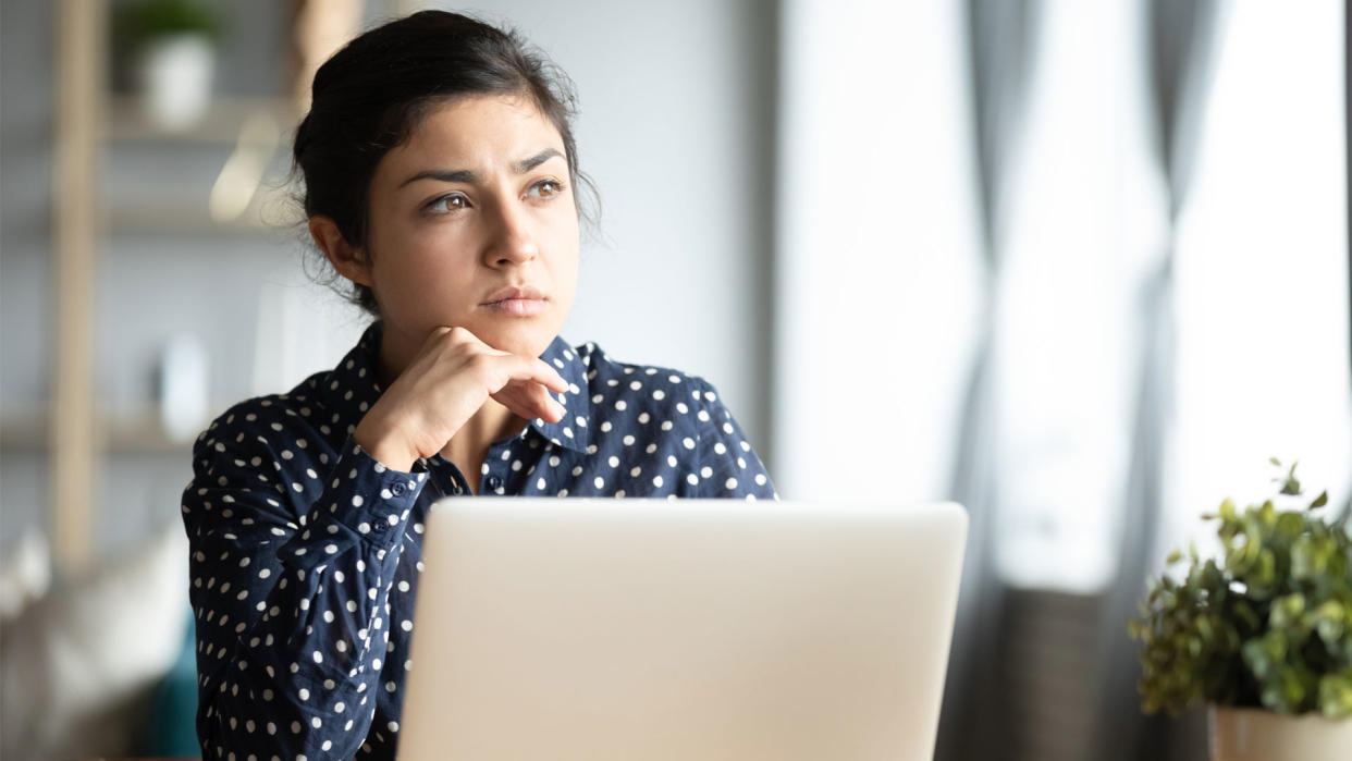  Person looking thoughtful using Windows laptop 