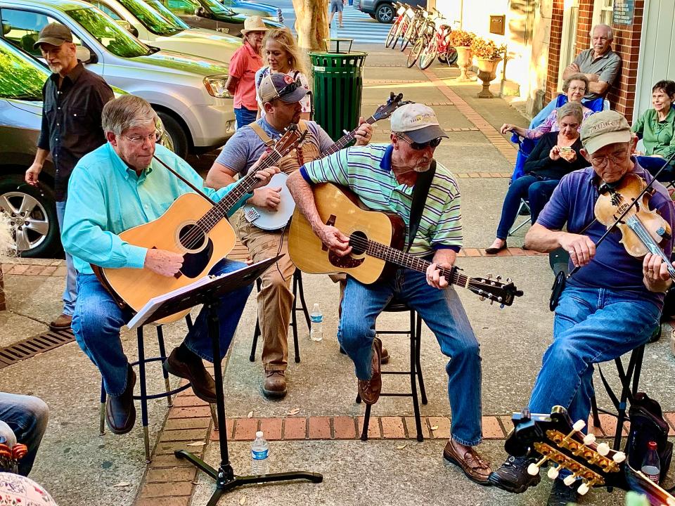Ward 2 Councilman Ken Wiles, left, performs with his bluegrass band outside of Puckett's in downtown Columbia during First Fridays in 2019.