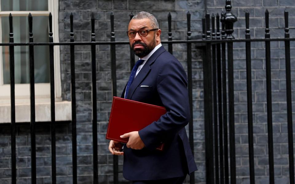 James Cleverly, the Home Secretary, is pictured this morning in Downing Street arriving for Cabinet