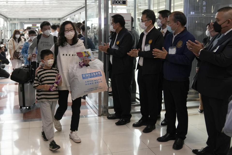 Chinese tourists arrive at Suvarnabhumi International Airport in Samut Prakarn province, Thailand, Monday, Jan. 9, 2023. Thailand is looking forward to hosting large numbers of vistors from China again after Beijing eased travel restrictions on Sunday. Chinese were about one-third of the total number of tourists visiting Thailand before the coronavirus pandemic, and the authorities hope they can help its lucrative tourism industry recover.(AP Photo/Sakchai Lalit)