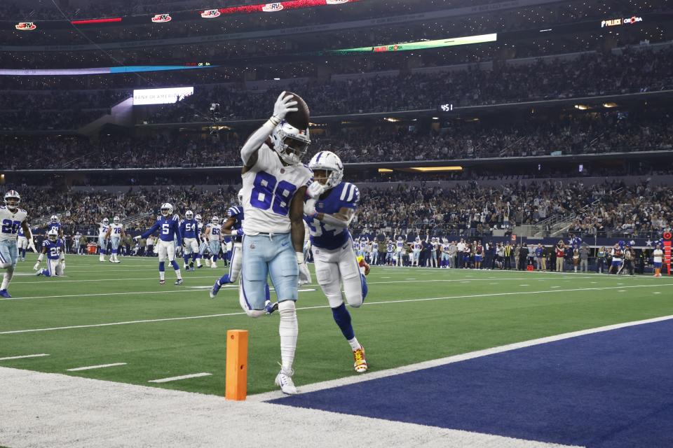 Dallas Cowboys' CeeDee Lamb (88) goes in for a touchdown against Indianapolis Colts' Isaiah Rodgers (34) during the first half of an NFL football game, Sunday, Dec. 4, 2022, in Arlington, Texas. (AP Photo/Michael Ainsworth)