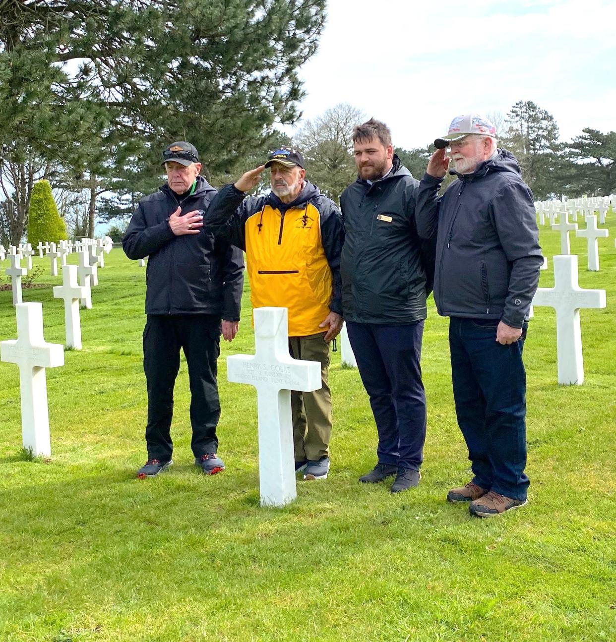 Paying respects at the Normandy American Cemetery are, from right, Bill Sheridan, Paul Johnson, Bert Guarnieri and a French guide.